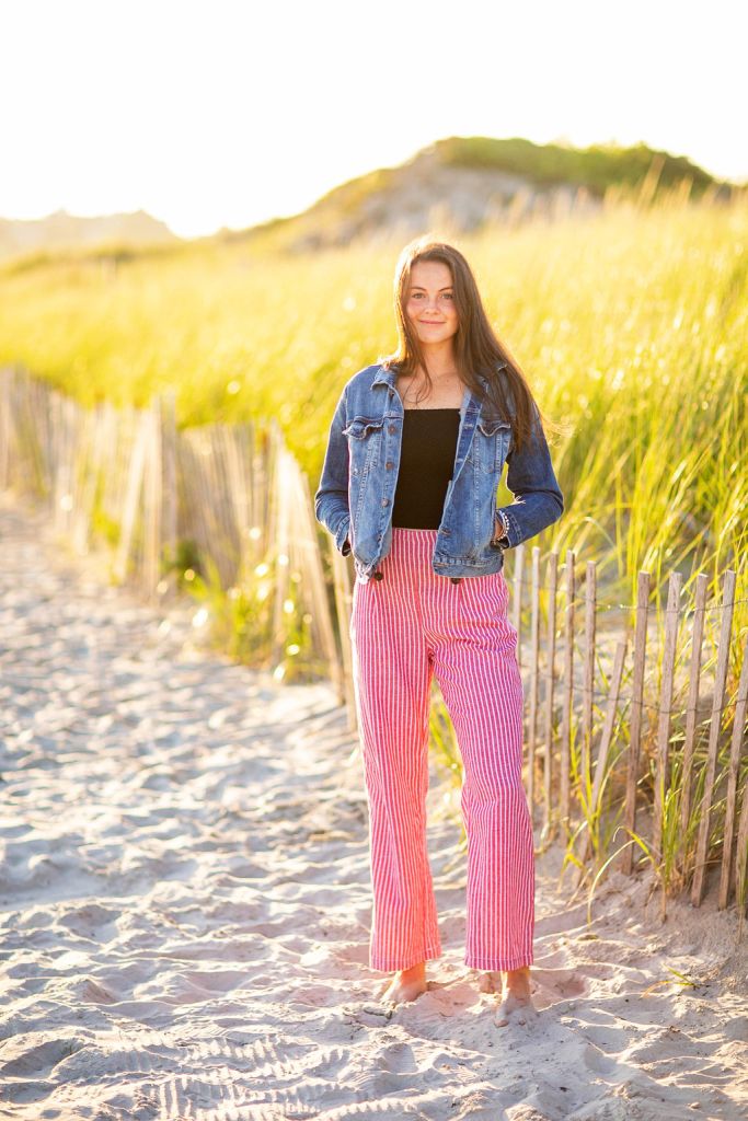 Girl poses for her senior session on the beach in Newport, RI