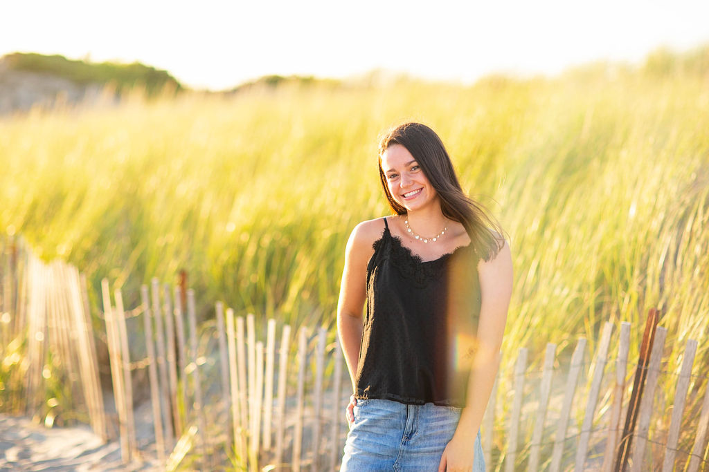 Girl poses for her senior session on the beach in Newport, RI