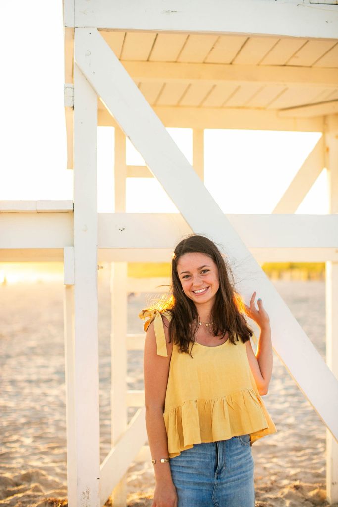 Girl poses for her senior session on the beach in Newport, RI