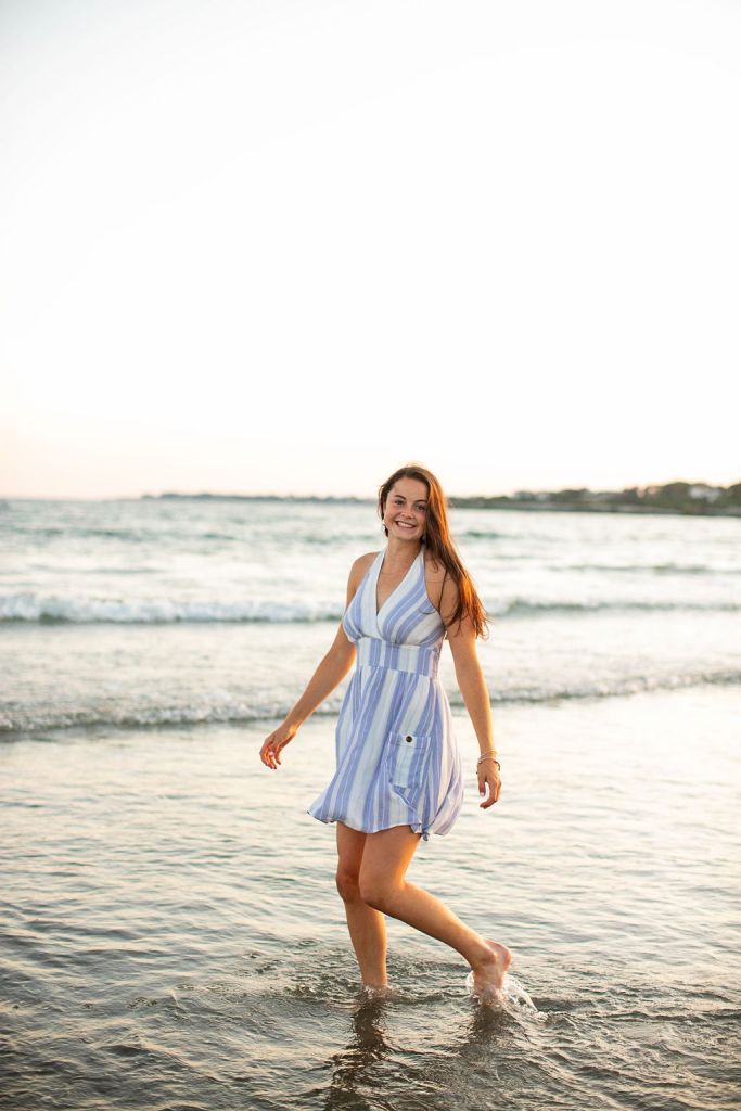 Girl poses for her senior session on the beach in Newport, RI