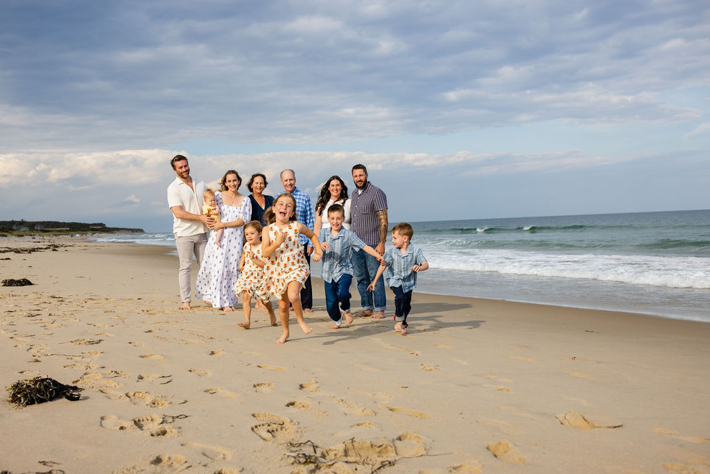 Kids run to the camera at extended family session on the beach on Block Island, RI