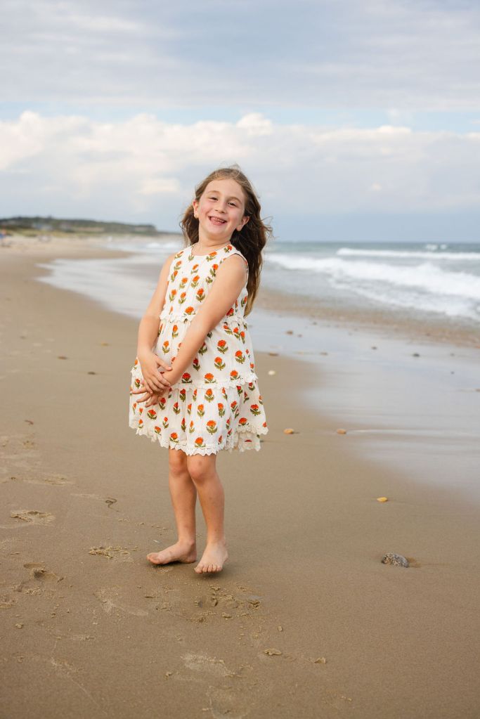 Little girl on the beach posing for family photos on block island