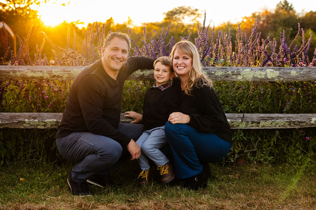 Family poses at The Farmer's Daughter in Kingstown, RI for their fall portrait session