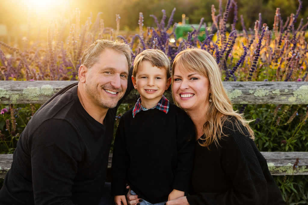Family poses at The Farmer's Daughter in Kingstown, RI for their fall portrait session